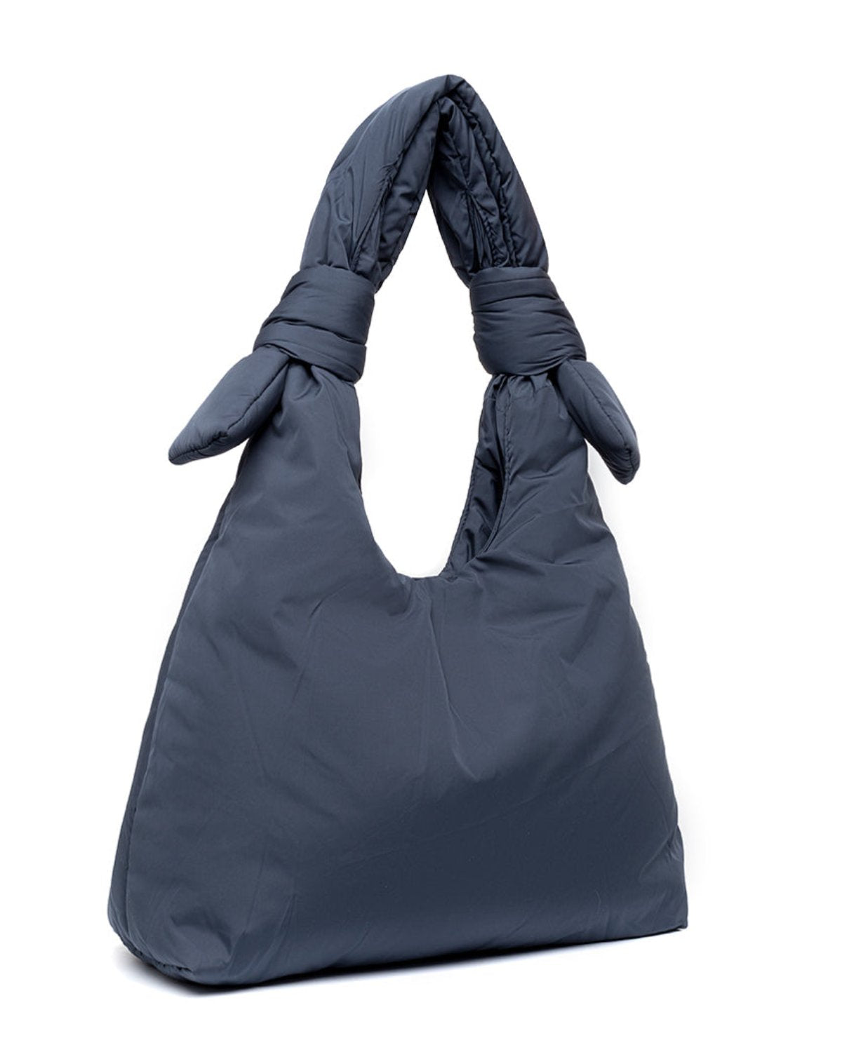 The jan-n-june BAG BIWA PUFFY REGULAR MAIBON is a dark gray, quilted bag with a soft, puffy texture, two knotted handles, and made from recycled polyester. It stands upright against a white background.