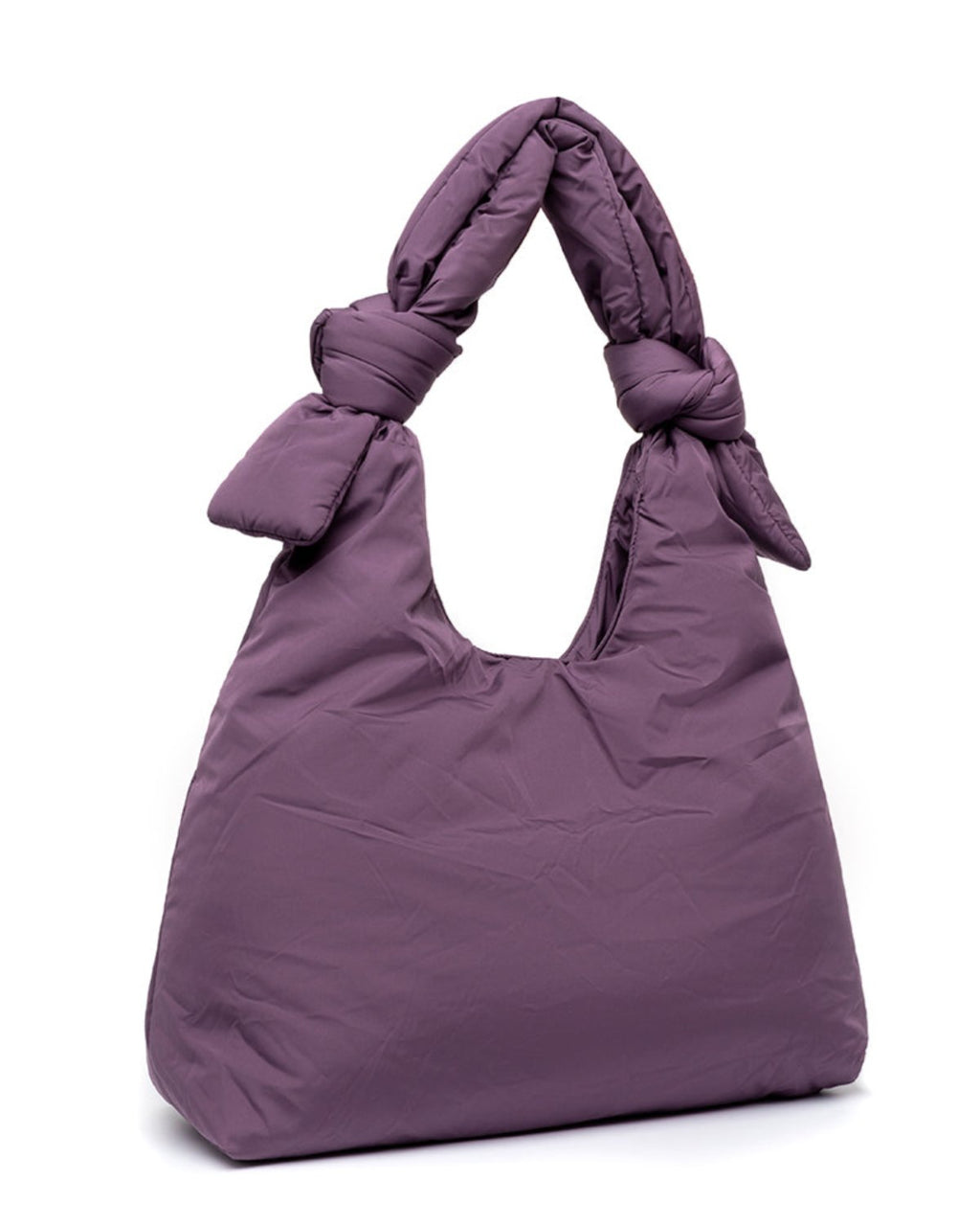 The jan-n-june BAG BIWA PUFFY REGULAR PLUM is a purple, quilted bag with two knotted handles, made from recycled plastic fabric and displayed upright on a white background.