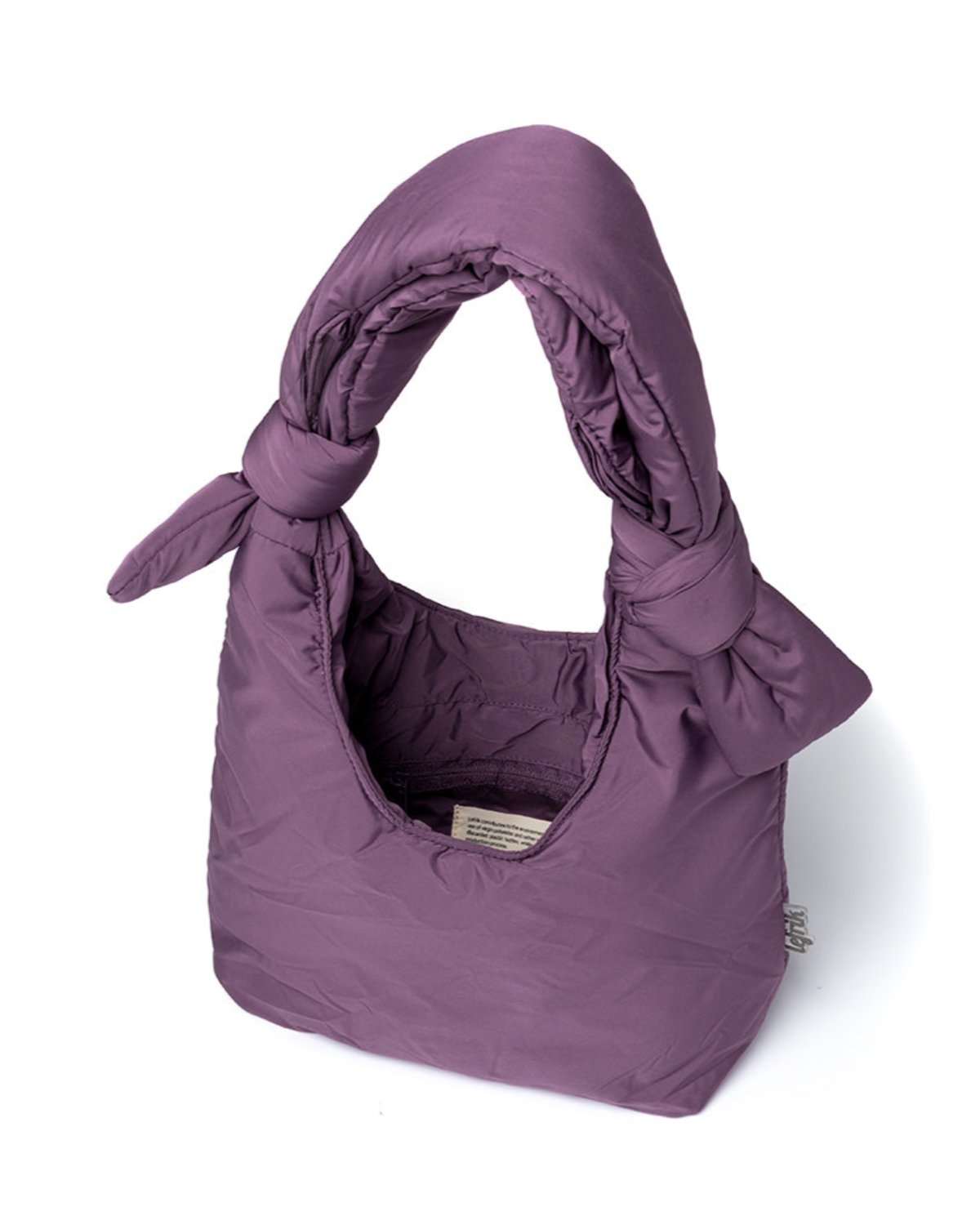 The BAG BIWA PUFFY MINI PLUM by jan-n-june is a quilted RPET mini bag in purple with a knotted handle, soft texture, open top, and visible lining tag.