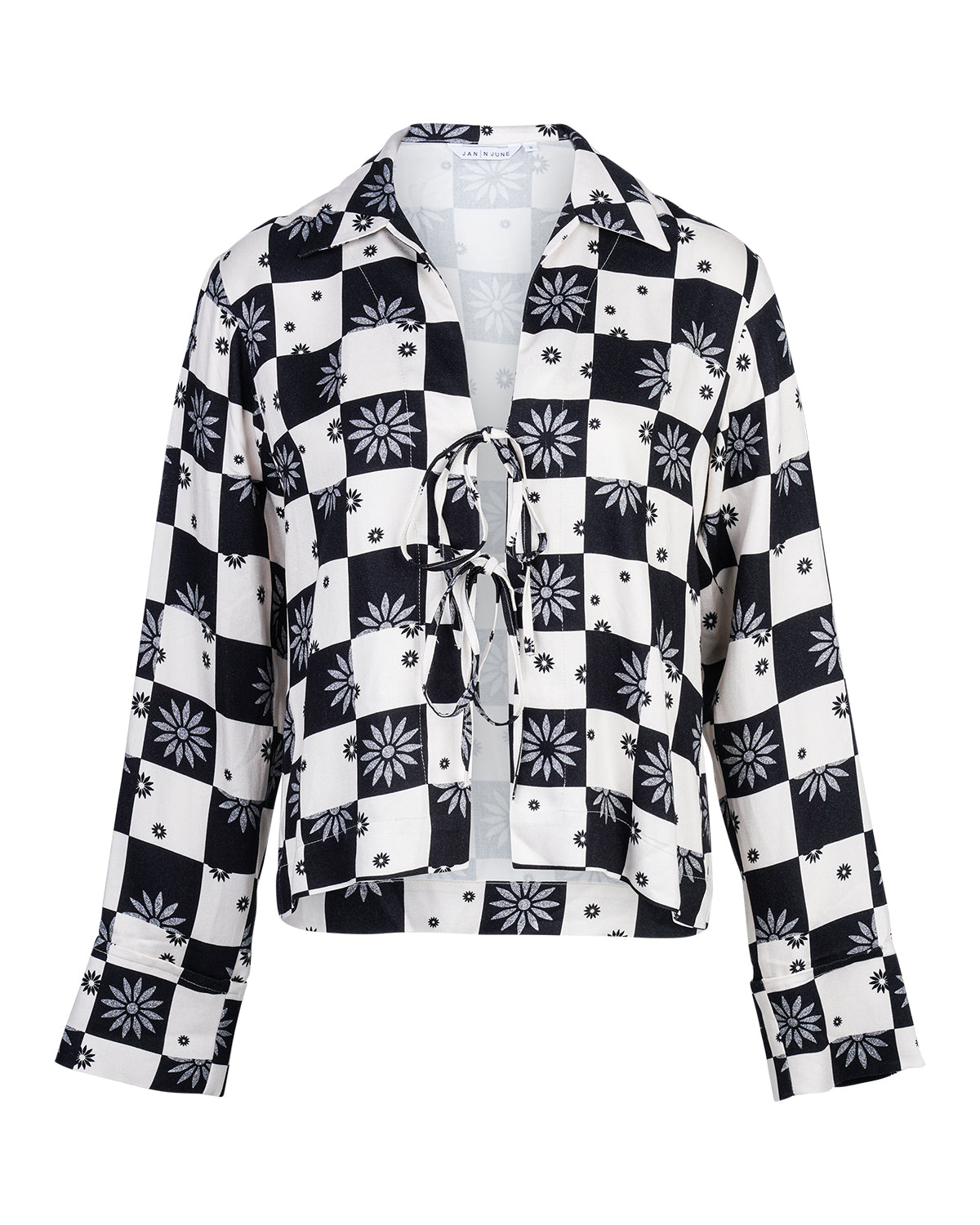The TIE BLOUSE KALUZ FLORAL SQUARE PRINT by jan-n-june is a long-sleeve blouse with black and white checks, floral patterns, small dots, a lace-up front, and a collar.