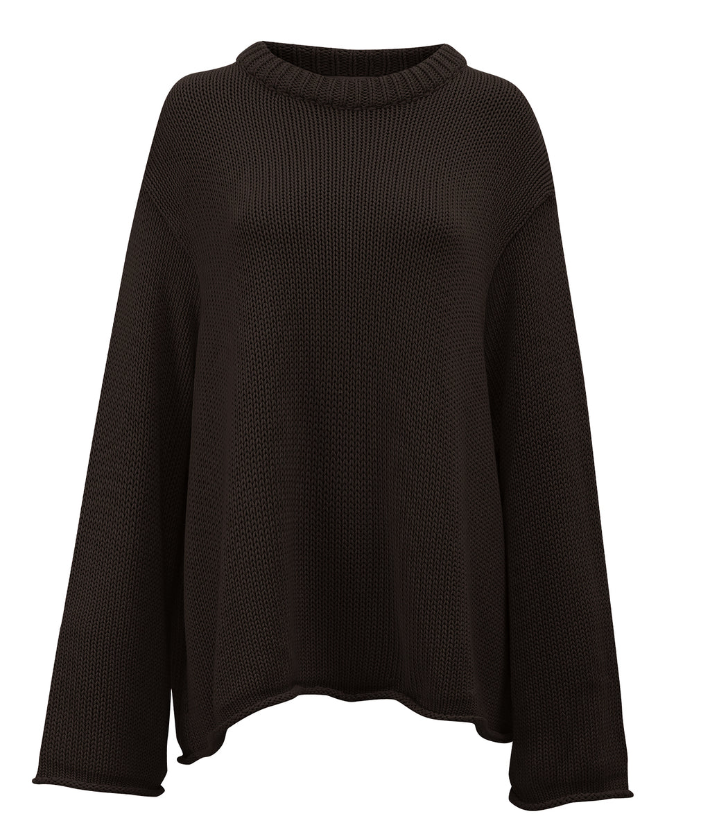 The jan-n-june JUMPER SONA CHOCOLATE GOTS is a loose-fitting, long-sleeve dark brown organic cotton jumper with a round ribbed neckline, shown on a plain white background.