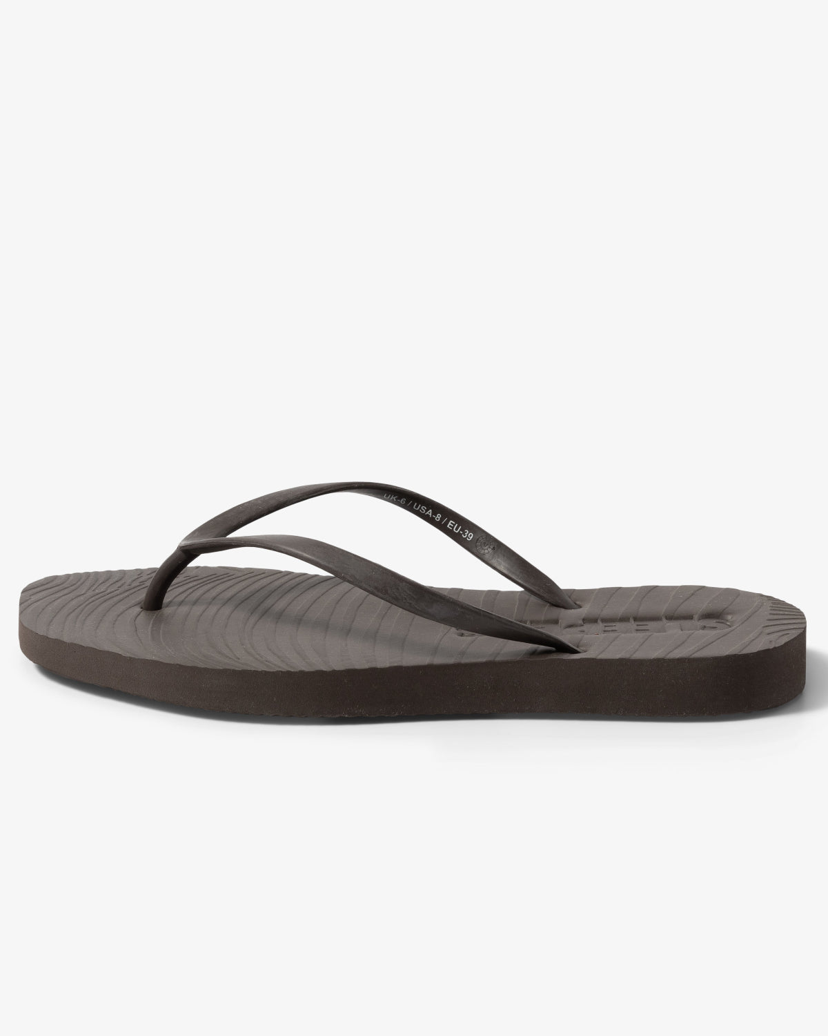 The jan-n-june SLEEPERS TAPERED FLIP FLOPS BROWN features a dark brown design with thin straps and a textured footbed—ideal for sustainable fashion lovers seeking biodegradable footwear.