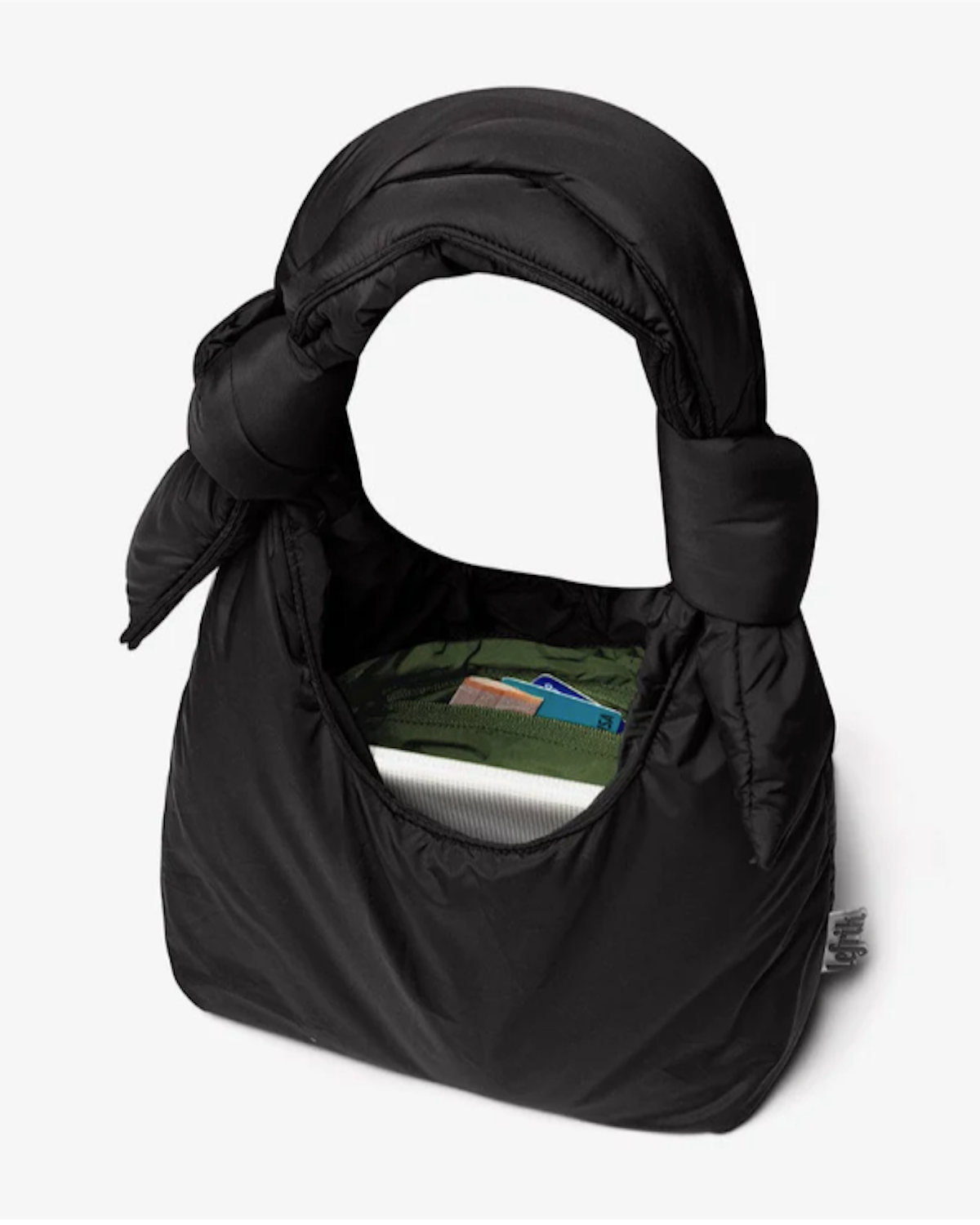 The BAG BIWA PUFFY MINI BLACK by jan-n-june is a black, padded mini handbag with a knotted handle, made from recycled fabric and shown open to reveal its spacious interior fitting various items.