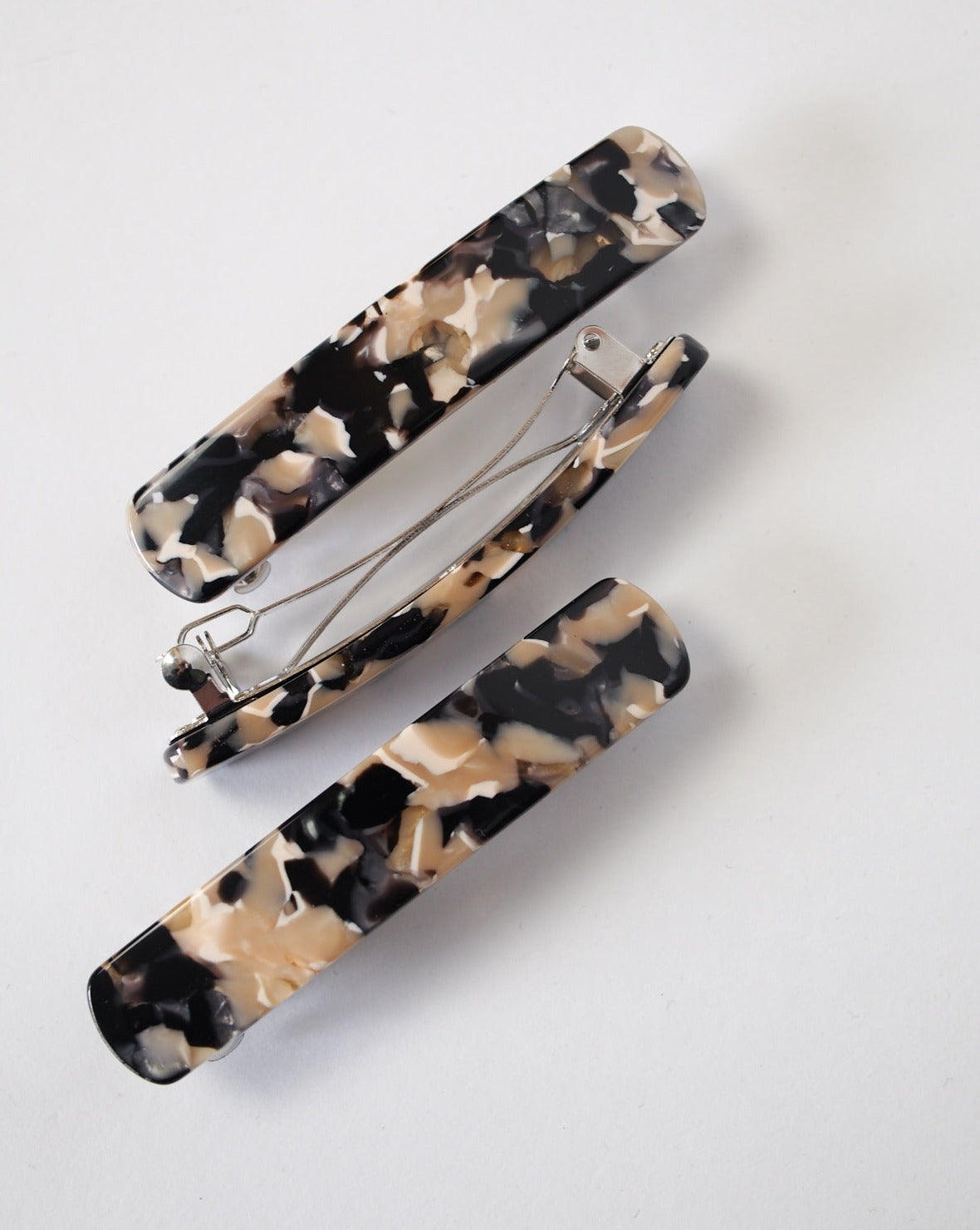 Two rectangular HEIRLOOM BARRETTE ABALONE hair clips by jan-n-june, crafted from Italian acetate in a marbled beige, black, and cream pattern, are shown on a white background—one closed, one open to reveal the clasp.