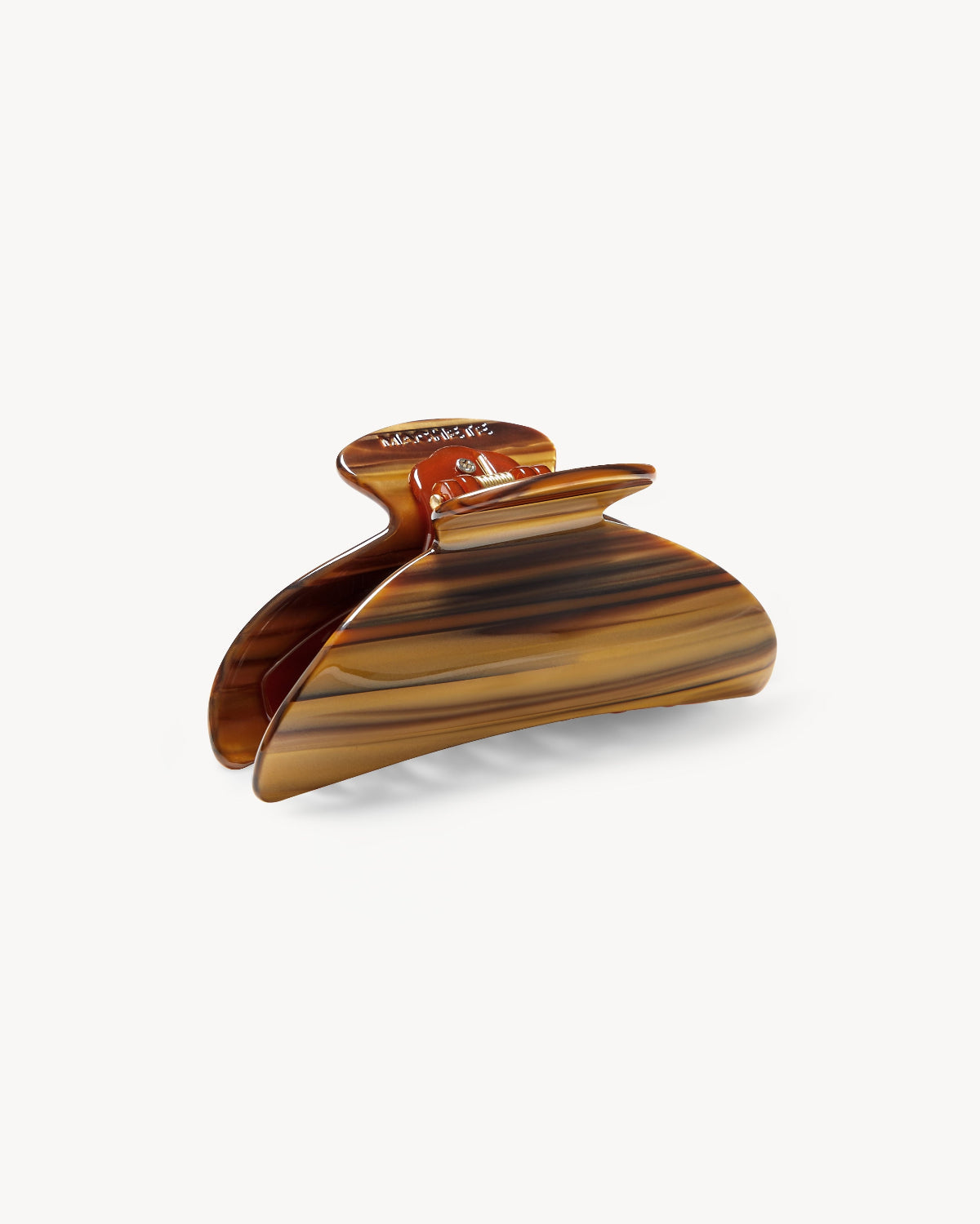 The MIDI HEIRLOOM CLAW TIGER'S EYE by jan-n-june is a brown tortoiseshell-patterned acetate hair clip with a curved, wide grip, made in Italy and shown on a plain white background.