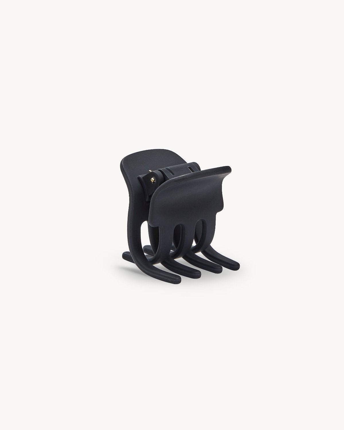 The jan-n-june MINI CLAW BLACK MATTE is a black plastic hair claw with interlocking curved prongs, displayed upright on a plain white background.