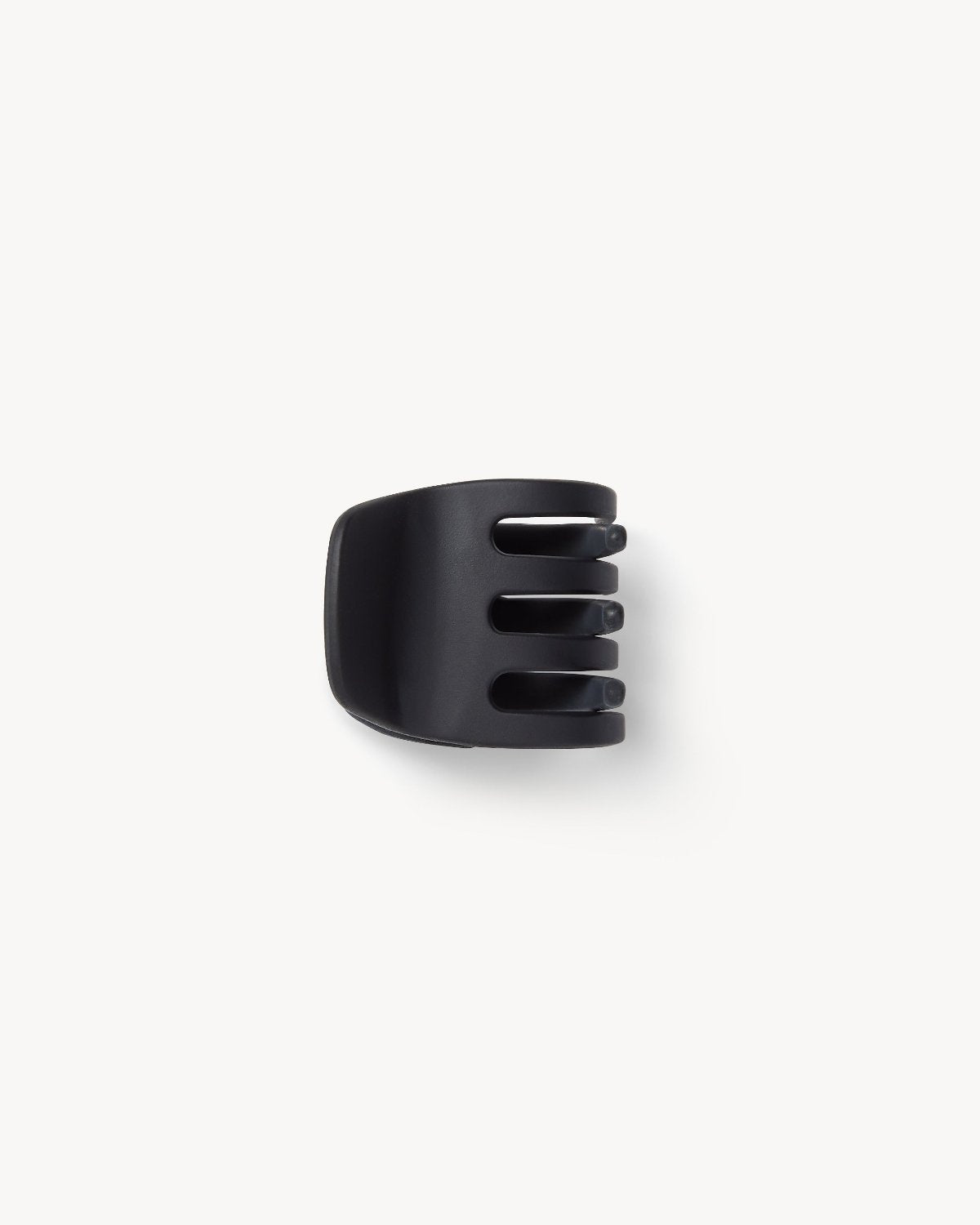 The MINI CLAW BLACK MATTE by jan-n-june is a handcrafted black matte plastic hair claw with four prongs, made in Italy and displayed on a plain white background.