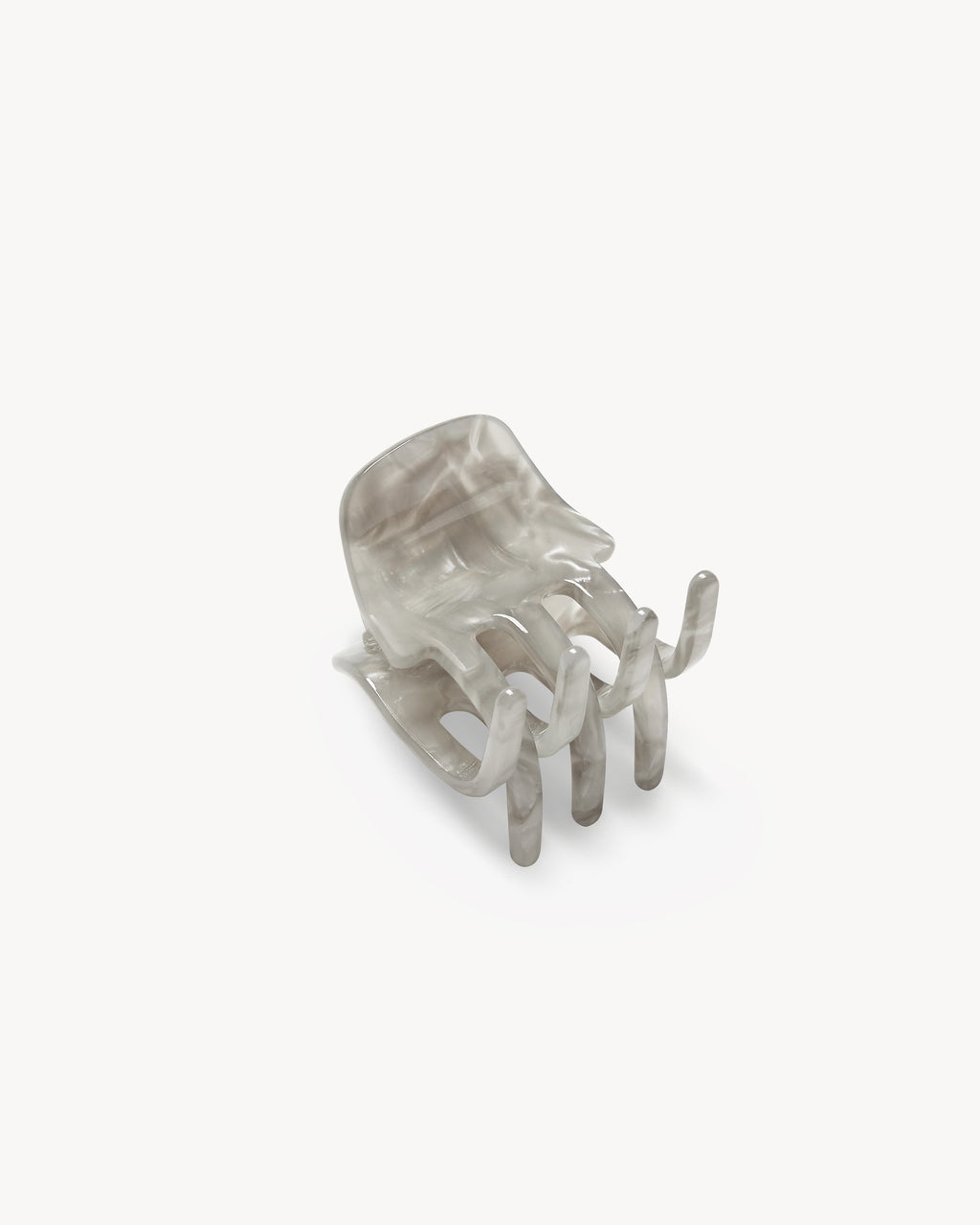 The MINI CLAW GREY SHELL by jan-n-june is a translucent gray chair, handcrafted in Italy, designed to resemble a human hand with spread fingers forming the seat and legs. Set against a plain white background.