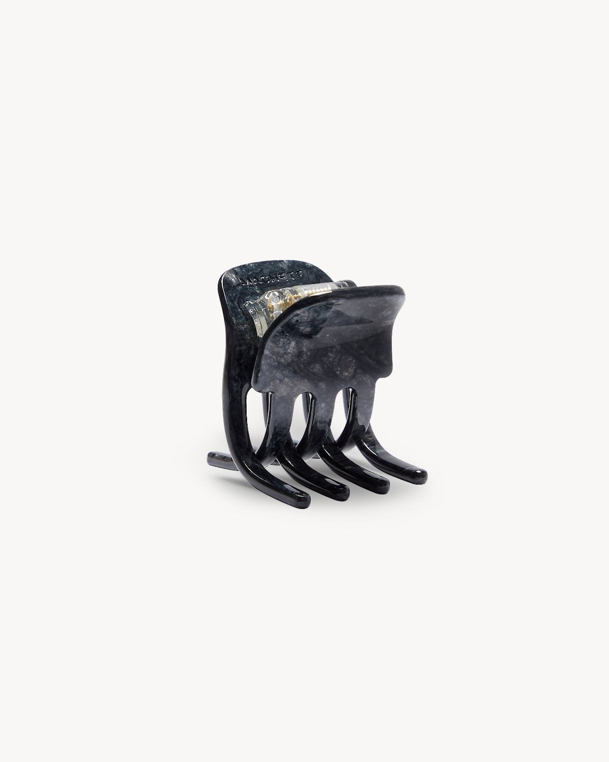 The jan-n-june MINI CLAW OBSIDIAN is a small, dark marbled hair claw with four rounded prongs, handcrafted in Italy and shown standing upright on a plain white background.