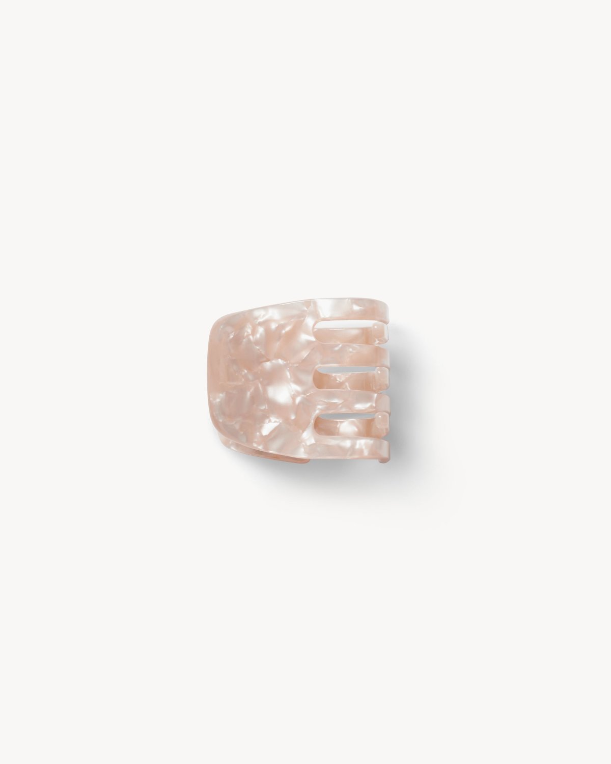 The MINI CLAW PEACH SHELL by jan-n-june is a small, sustainable pink marbled hair clip with four rounded prongs, shown on a white background.