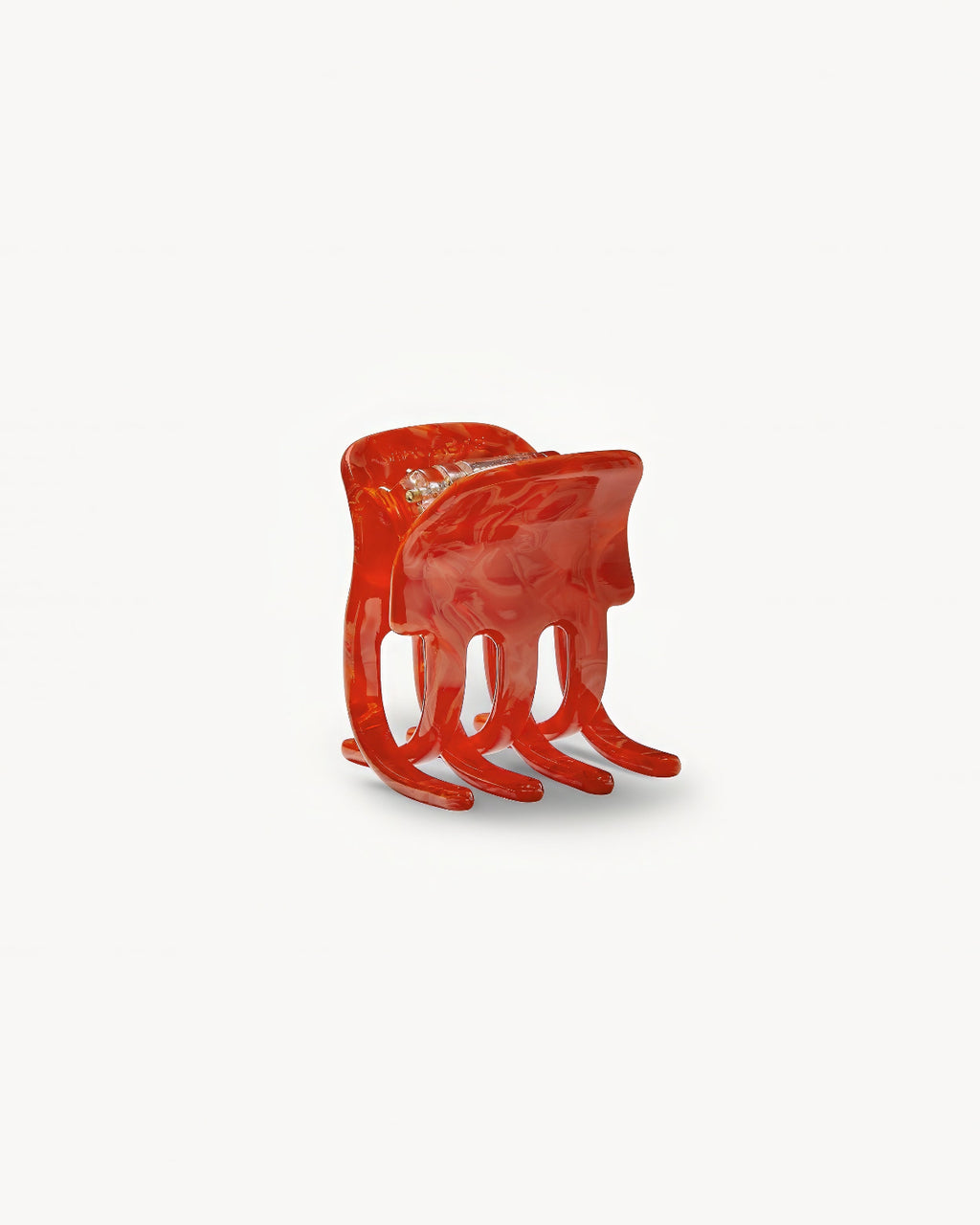 The MINI CLAW POPPY by jan-n-june is a glossy red sculptural chair with four curved legs and an abstract, fluid form, resembling a melted organic shape, showcased against a plain white background.