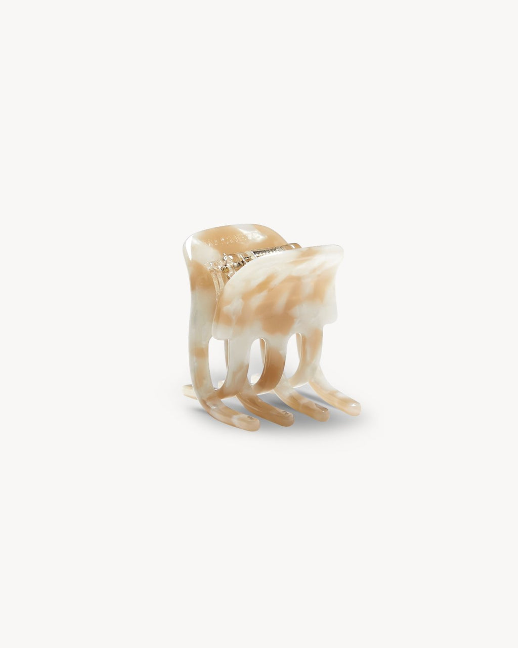 The MINI CLAW TAUPE SHELL by jan-n-june is a marbled beige and white hair claw, handmade in Italy from sustainable plastic with a curved shape and interlocking teeth, shown on a plain white background.
