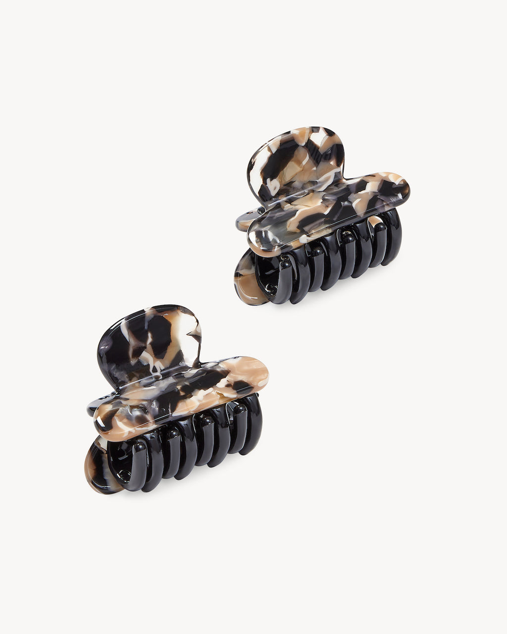 Two marbled MINI HEIRLOOM CLIP ABALONE hair claws by jan-n-june, featuring black teeth and handcrafted in Italy with French-inspired chic, are displayed against a plain white background.