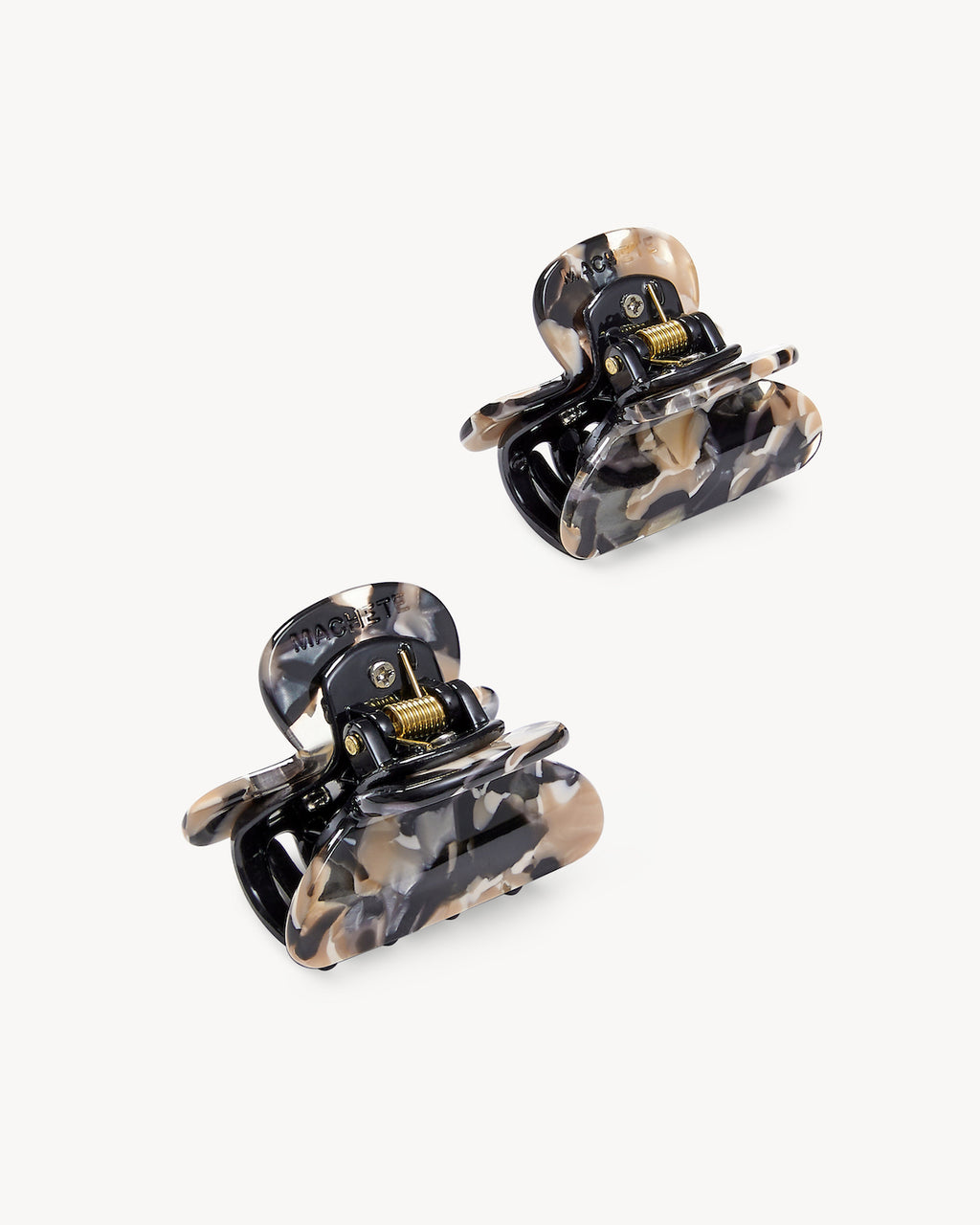 The jan-n-june MINI HEIRLOOM CLIP ABALONE set includes two handcrafted small hair claw clips with a marbled black, beige, and cream pattern for a chic look. Made in Italy, displayed on a plain white background.
