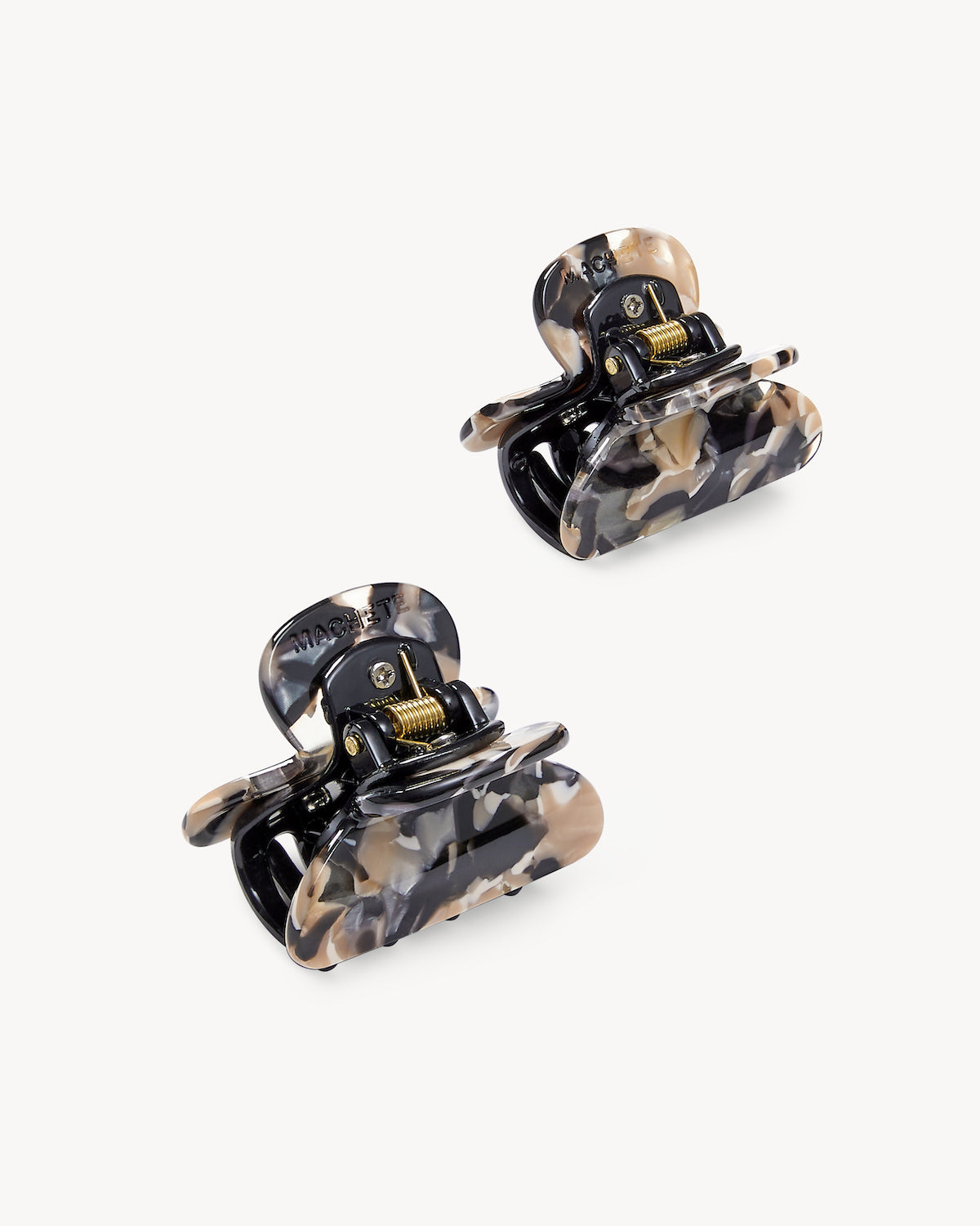 The jan-n-june MINI HEIRLOOM CLIP ABALONE set includes two handcrafted small hair claw clips with a marbled black, beige, and cream pattern for a chic look. Made in Italy, displayed on a plain white background.