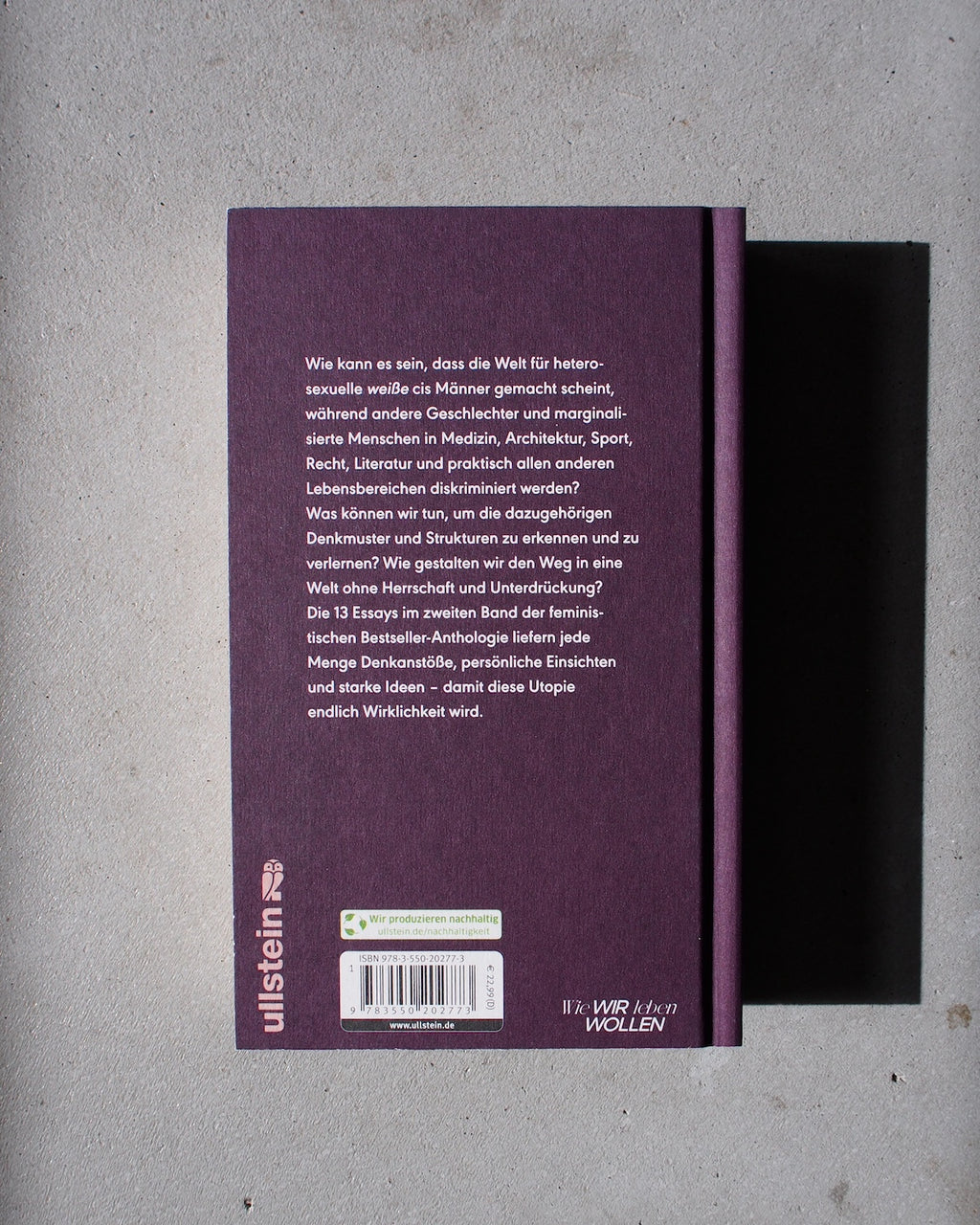 A purple hardcover book titled UNLEARN PATRIARCHY 2 by jan-n-june rests face down on a light gray surface. The back cover shows German text, a bottom barcode, and the publishers logo ullstein to the left of this feminist anthology.