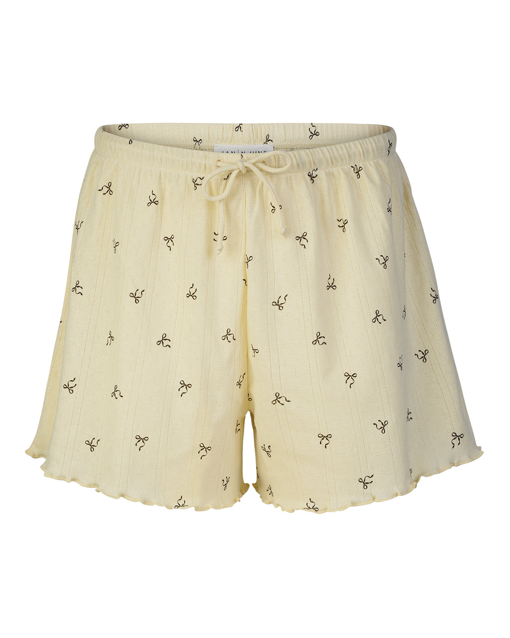 The POINTELLE PYJAMA SHORTS BUTTERBOW GOTS by jan-n-june feature cream pointelle fabric with thin stripes, black abstract designs, an elastic drawstring waist, ruffled hems, and are made from soft GOTS certified organic cotton. Displayed on white.