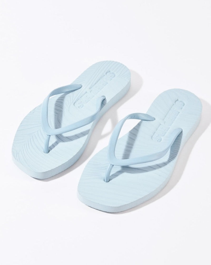 A pair of SLEEPERS TAPERED FLIP FLOPS in Angel Blue by jan-n-june, featuring textured soles and biodegradable materials, displayed on a white background.