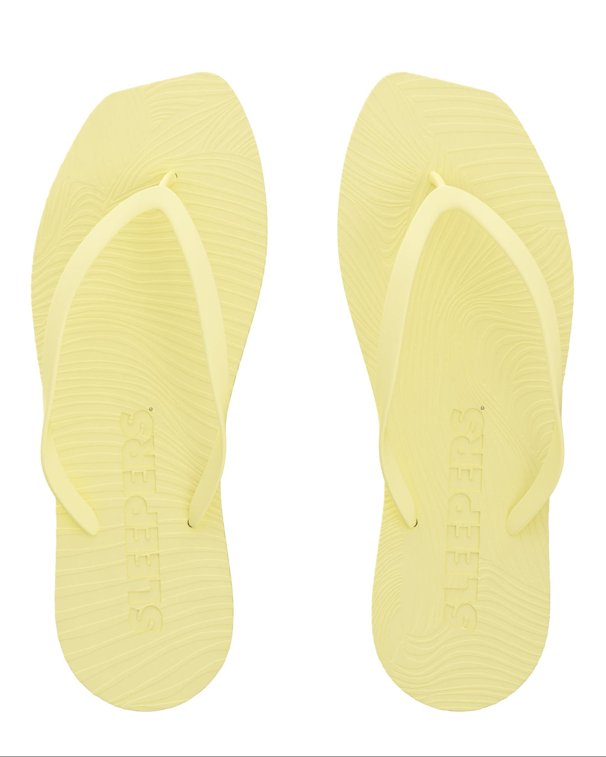 The jan-n-june SLEEPERS TAPERED FLIP FLOPS MELLOW YELLOW are pale yellow flip flops with textured soles and SLEEPERS embossed footbeds, made from biodegradable materials and shown on a white background.